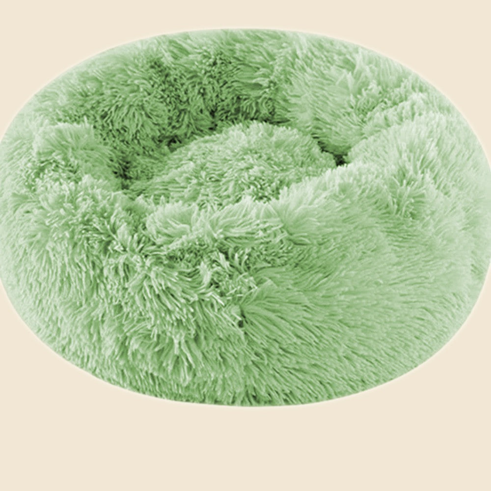 Denwell plush donut pet bed in sage green, on cream background